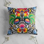 Folkstar Two Roosters folk pillow on marble surface with dried wildflowers