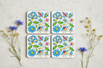 Folkstar Kashubian folk cork coasters arranged in flat lay on marble surface