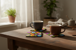 Folkstar Łowicz black folk cork coasters on a kitchen table with dark ceramic mugs