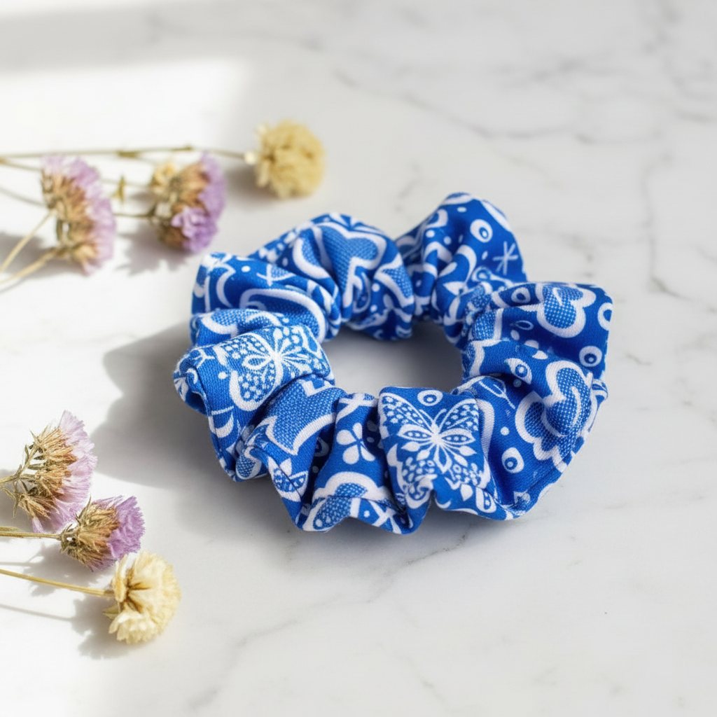 Folkstar Kujawy folk scrunchie on marble surface with dried wildflowers
