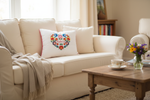 Monart Babcia white embroidered folk cushion on a cream linen sofa with tea and fresh flowers