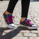 Folkstar Łowicz black folk sneakers close-up on cobblestone street
