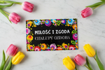 Folkstar Miłość i Zgoda metal sign flat lay on marble surface with fresh pink and yellow tulips