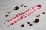 Folkstar #Polska shoelaces laid flat on marble surface with red and white flowers