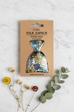 Folkstar Folk Zapach Bystra Woda freshener on marble surface with dried wildflowers and eucalyptus